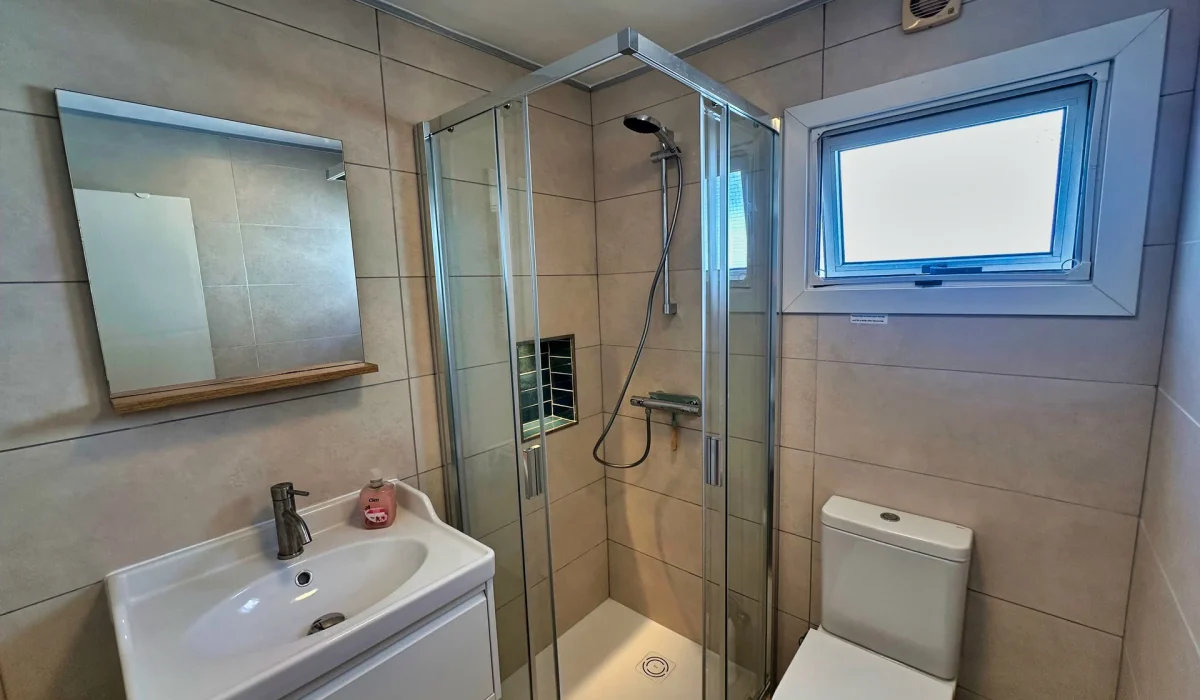 Newly renovated bathroom with shower cubicle