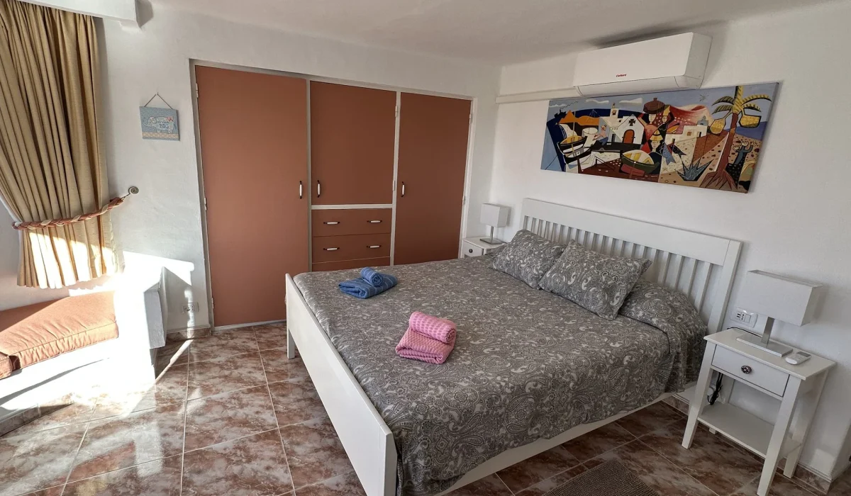 Bedroom 1 with double bed, air conditioning and en-suite bathroom
