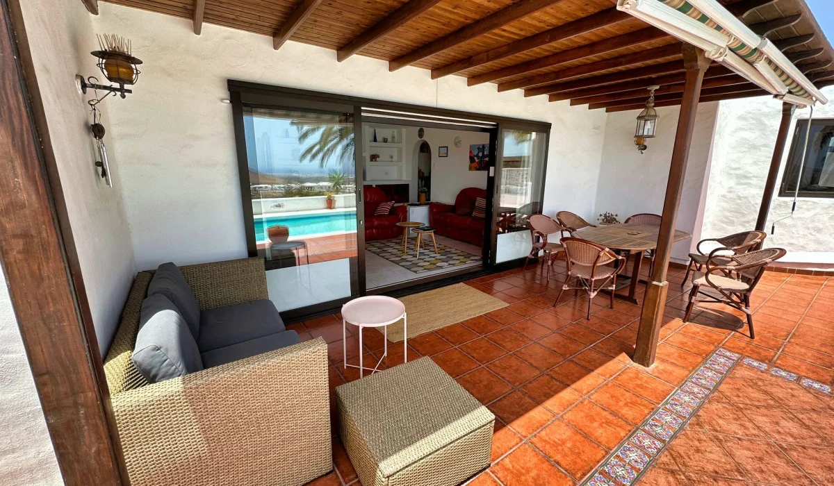 Covered terrace with lounge sofa and dining table